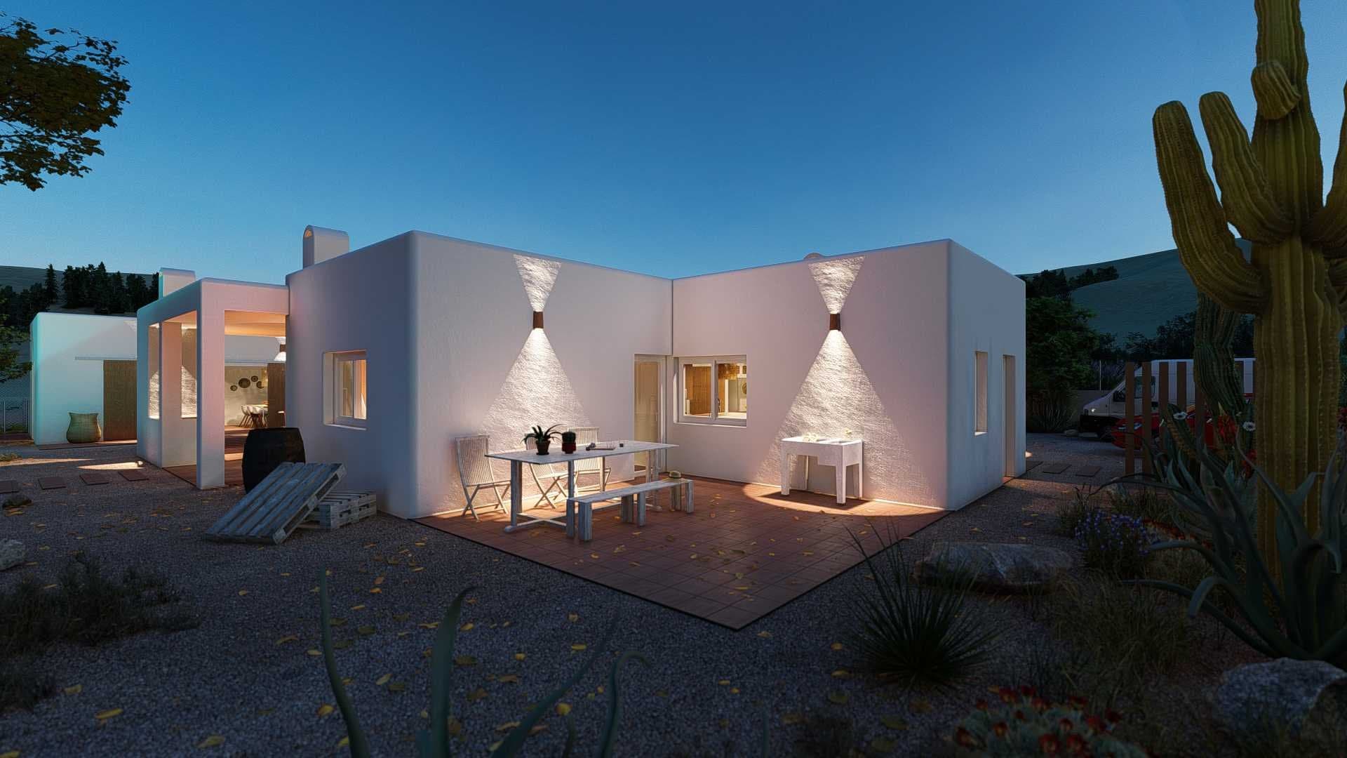Vivienda unifamiliar moderna iluminada de noche con mesa de exterior en la fachada